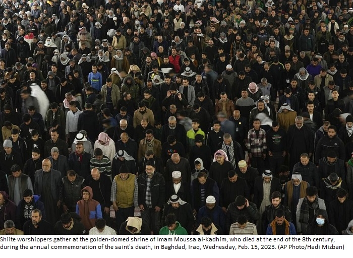 Shiite pilgrims march through Baghdad surrounded by security